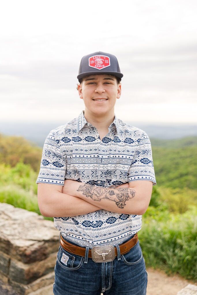 Graduating senior smiling during golden hour photo shoot in Shenandoah National Park