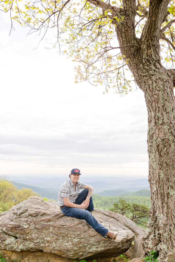 High school senior posing at sunrise with mountain views in Shenandoah National Park
