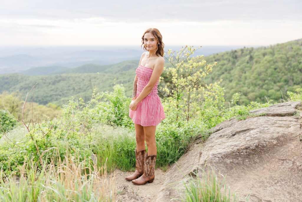 High school senior posing at sunrise with mountain views in Shenandoah National Park