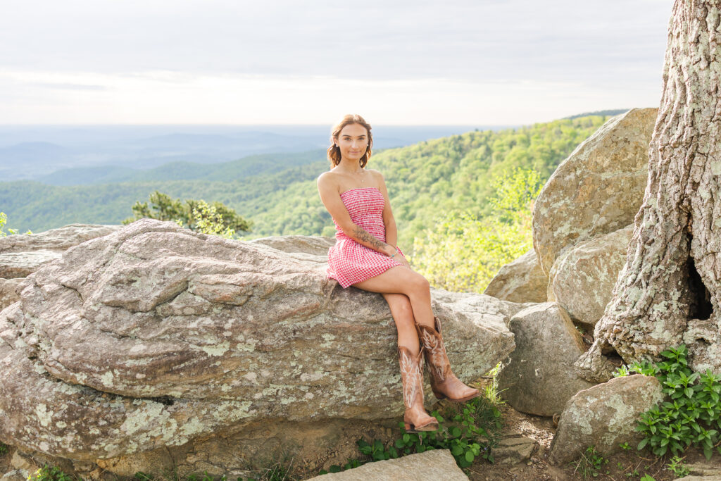 Graduating senior smiling during golden hour photo shoot in Shenandoah National Park